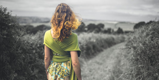 Girl walking alone in a field