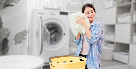 Women taking a hoodie out of washing machine