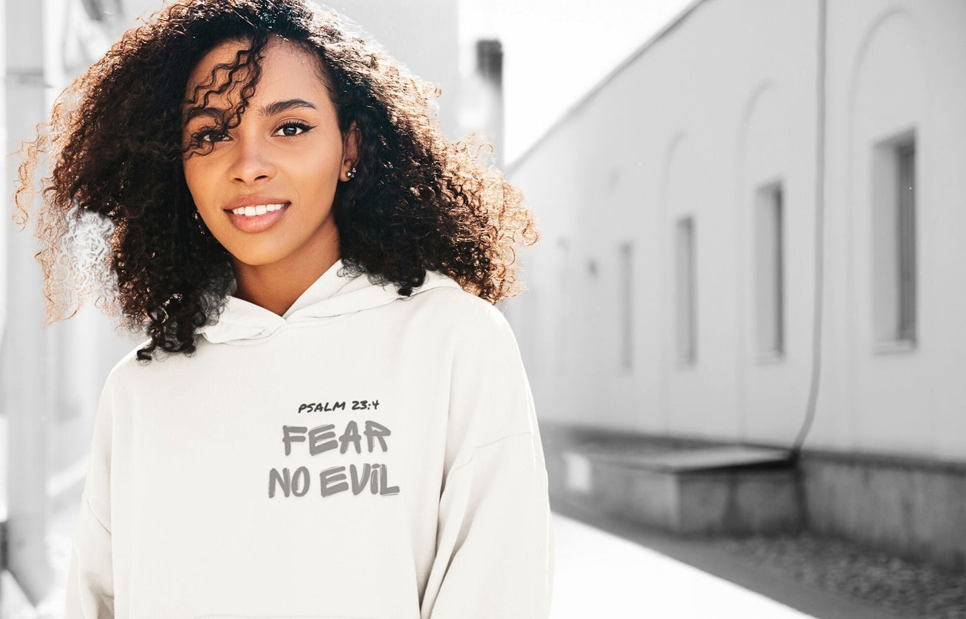 Christian girl in a Psalm 23 hoodie smiling