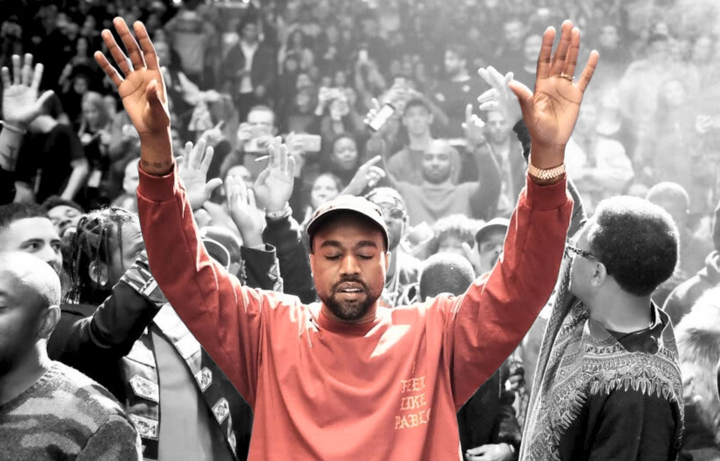 Kanye West in sweater praying to God