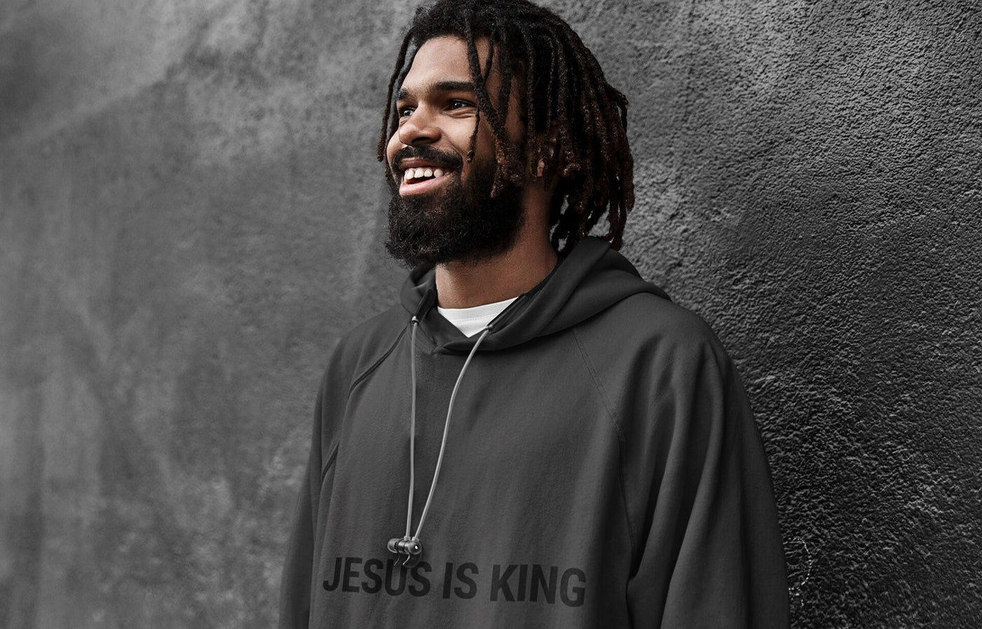 A man wearing a black Jesus hoodie
