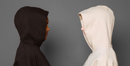 Two girls wearing pullover hoodies