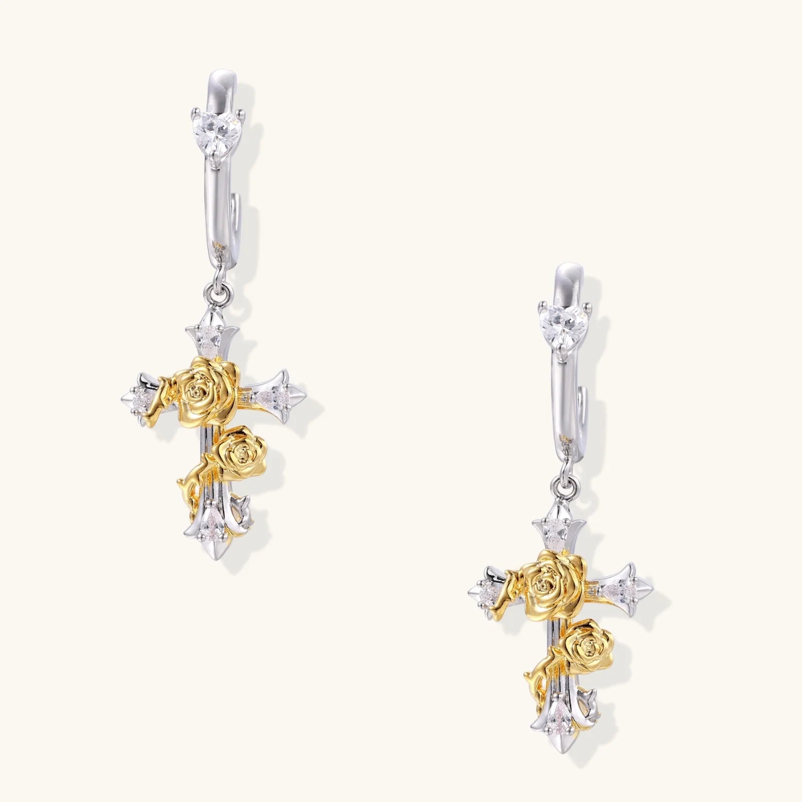 Two-tone cross earrings with gold roses and crystal stars on silver hoops, dangle drop style on white background.