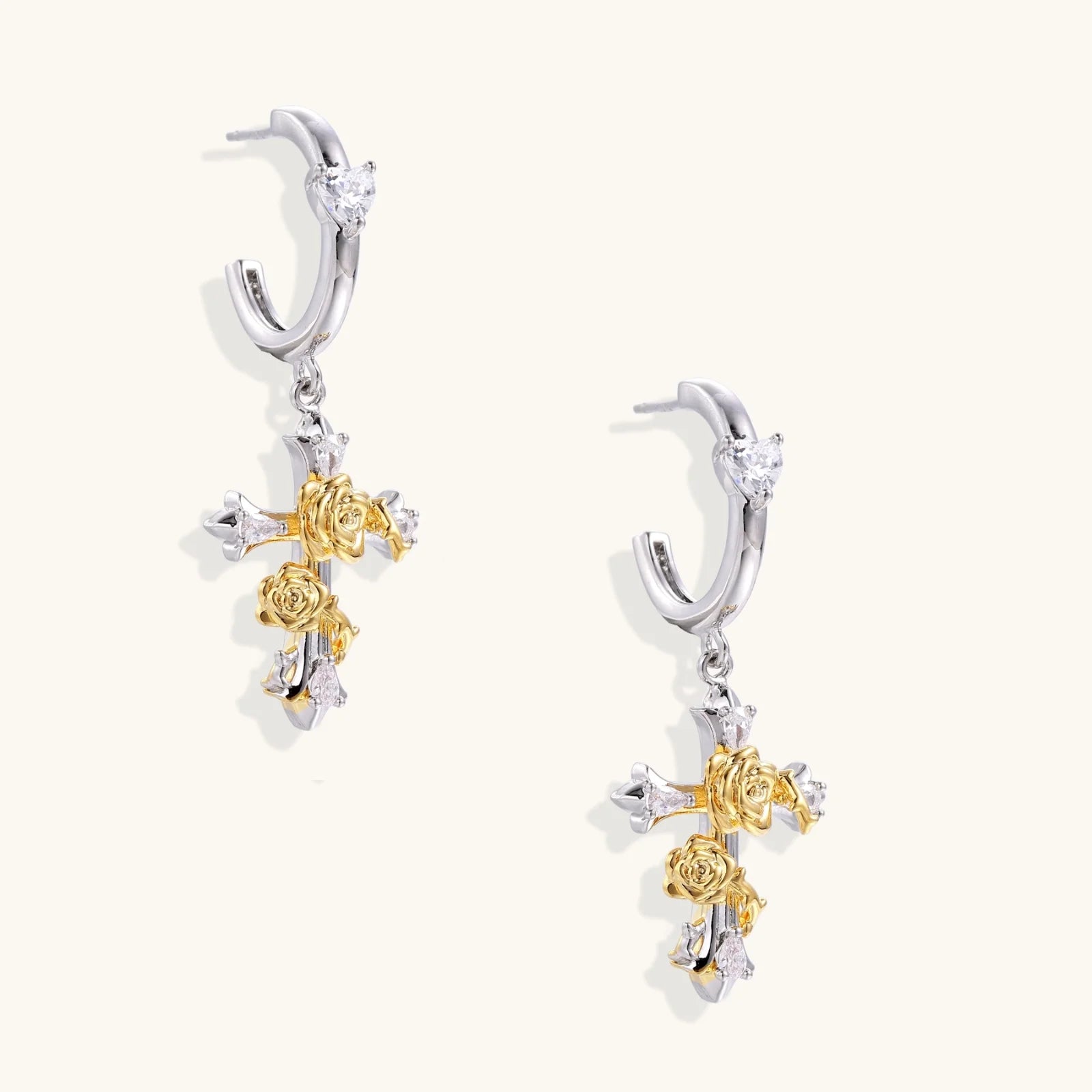 Two-tone cross earrings with gold roses and crystal stars on silver hoops, dangle drop style on white background.